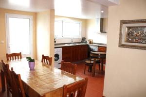 a kitchen with a table and a dining room at A Casa de Santana in Santana