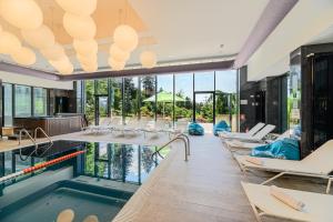 a pool with lounge chairs and a swimming pool at Complex Hotelier COTA O MIE in Sinaia