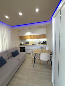 a living room with a couch and a table at Lakefront House in Pogradec