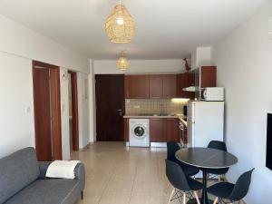 a living room with a couch and a table at Horizon Court in Kiti +10 photos