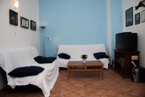 a living room with two beds and a tv at Apartments Sundance in Okrug Donji