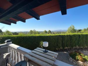 a wooden bench sitting on a balcony with a view at Finca Malata in Turís +16 photos