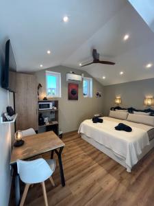 a bedroom with a large bed and a table and a dining room at Finca Malata in Turís