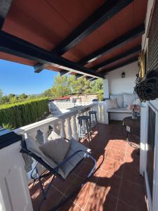 a patio with chairs and a couch on a balcony at Finca Malata in Turís
