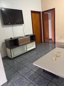 a entertainment center with a flat screen tv on a wall at Casa confort - Vicente pires in Brasília +11 photos