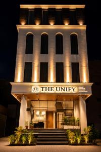 a building with a sign that reads the university at Hotel The Unify in Jāmb