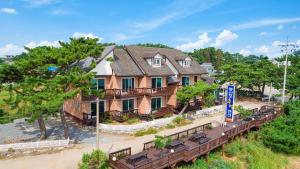 an aerial view of a house with a train at mongsanpo cueogpensyeon in Taean