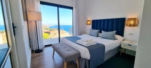a bedroom with a bed with a view of the ocean at Maresía Village in Los Realejos +158 photos