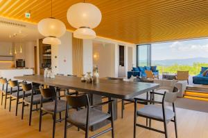 a dining room with a large table and chairs at Villa Mori - Odin Hills in Kutchan