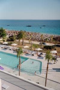 a view of the beach from the balcony of a resort at Kaiser Resort in Dhërmi
