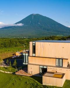 an image of a building with a mountain in the background at Villa Mori - Odin Hills in Kutchan