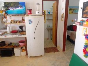 a white refrigerator in a room with a sink at Chale Canoa Beach in Canoa Quebrada +46 photos