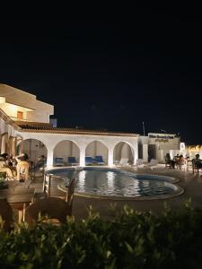 a swimming pool in the middle of a patio at night at Blue Beach Club in Dahab