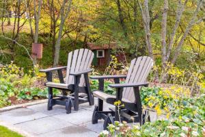 two chairs sitting next to each other in a garden at 5 o'clock somewhere in Masterton +31 photos