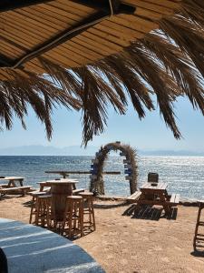 a group of tables and chairs on the beach at Blue Beach Club in Dahab