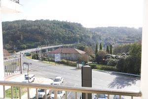 a view of a parking lot with cars on a road at O Cruceiro da Ulla in Vedra