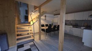 a kitchen and dining room with a table and chairs at Big 3-bedroom flat with new kitchen in Brienz