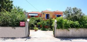 a yellow house with a gate in front of it at Kontara Studios Anaxos in Petra