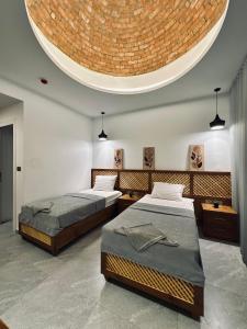 two beds in a room with a circular ceiling at Blue Beach Club in Dahab +62 photos