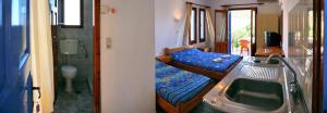 a bathroom with a bed and a sink and a tub at Kontara Studios Anaxos in Petra