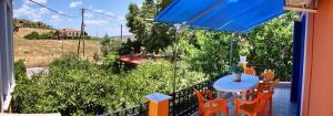 a patio with a table and chairs on a balcony at Kontara Studios Anaxos in Petra