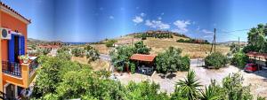 a view of a house with a hill in the background at Kontara Studios Anaxos in Petra