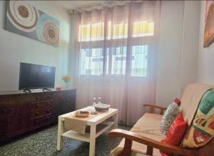 a living room with a television and a coffee table at Aguilon in Arrecife