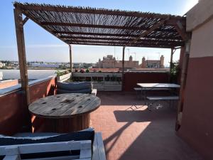 a patio with a table and chairs on a roof at Baires&Blo Ático duplex, Terraza chillout exclusiva y vistas al mar in Benicarló