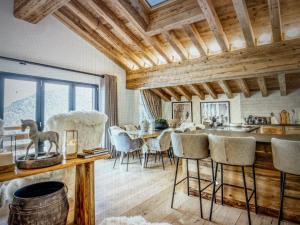 a kitchen and dining room with a table and chairs at Crystal Lodge St Moritz in St. Moritz