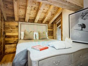 a bedroom with a bed in a log cabin at Crystal Lodge St Moritz in St. Moritz