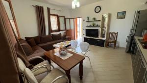 a living room with a couch and a table at Vacation Home Hoxha in Rrotull
