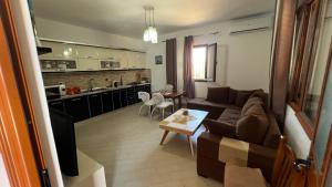 a living room with a couch and a table at Vacation Home Hoxha in Rrotull