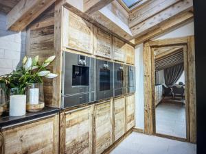 a living room with wooden walls and a ceiling at Crystal Lodge St Moritz in St. Moritz +9 photos