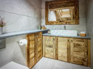 a bathroom with a sink and a mirror at Crystal Lodge St Moritz in St. Moritz