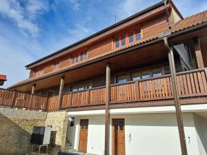 a building with a wooden deck on top of it at Drevenica Šumiac in Šumiac