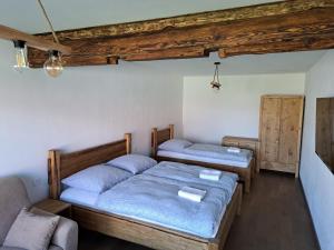 a room with two beds and a couch at Drevenica Šumiac in Šumiac