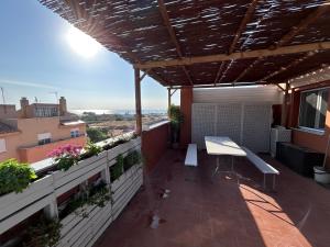 a patio with a bench on a balcony at Baires&Blo Ático duplex, Terraza chillout exclusiva y vistas al mar in Benicarló +50 photos