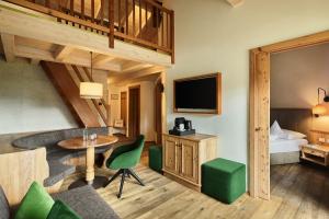 a hotel room with a bed and a living room at Hotel AUI in Maranza