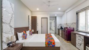 a bedroom with a large bed in a room at homly hotel in Indore +1 photo