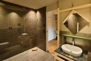 a bathroom with a shower and a toilet at Hotel AUI in Maranza +40 photos