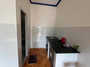 a kitchen with a sink and a counter top at VitaSea Mui Ne homestay & pool in Mui Ne
