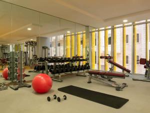 a gym with a mirror and lots of exercise equipment at ibis Doha in Doha