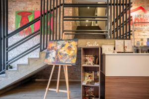 a painting on a stand in front of a staircase at Art хостел-готель "Адреналін" in Lutsk