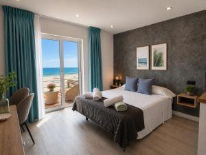 a bedroom with a large bed with a view of the ocean at Villa Dru in Roquetas de Mar