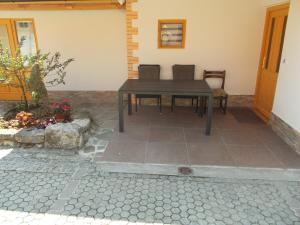 a table and chairs sitting on a patio at Prima Apartment in Podbočje +28 photos