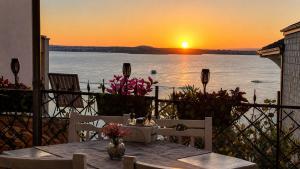 a table with a view of the ocean at sunset at ORION Guest House in Sozopol
