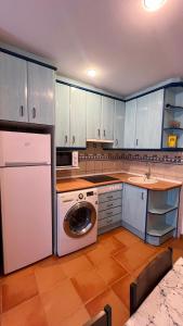 a kitchen with a washing machine in the middle of it at V.U.T. EL HONGO in Mora de Rubielos +11 photos