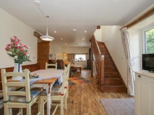a dining room and living room with a table and chairs at Buzzards Breg in Builth Wells