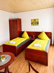 a room with two beds and a table at Waldschloss Rathenow in Rathenow