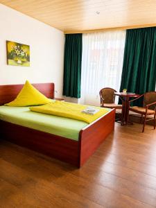 a bedroom with a bed and a table with chairs at Waldschloss Rathenow in Rathenow +4 photos